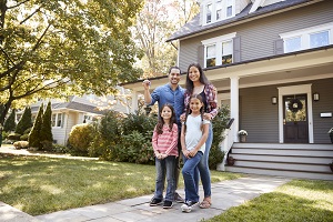 family standing outside home